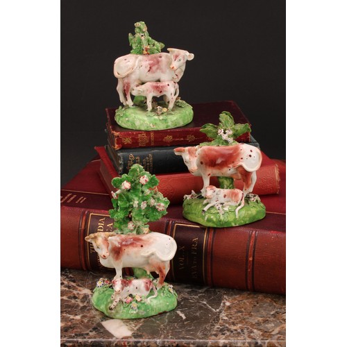 174 - A Derby model, of a cow and her calf, beside a tree, 15cm high, c.1815; others similar (3)