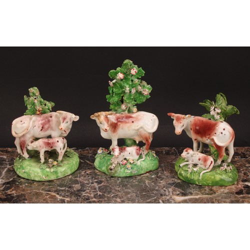 174 - A Derby model, of a cow and her calf, beside a tree, 15cm high, c.1815; others similar (3)