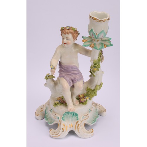 181 - A pair of Continental porcelain figural candlesticks, probably Samson, modelled with seated putto, e... 