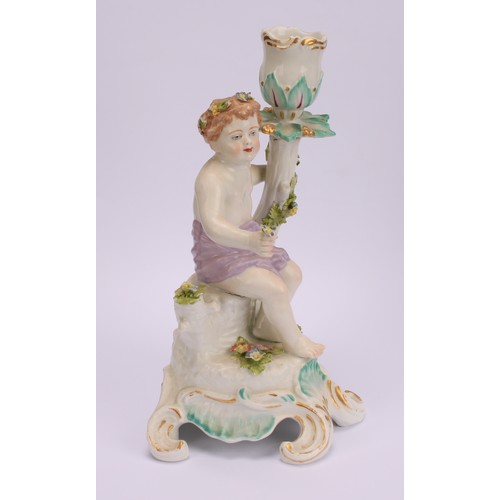 181 - A pair of Continental porcelain figural candlesticks, probably Samson, modelled with seated putto, e... 