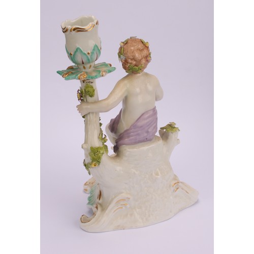 181 - A pair of Continental porcelain figural candlesticks, probably Samson, modelled with seated putto, e... 