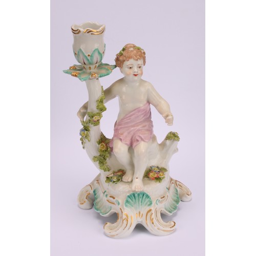 181 - A pair of Continental porcelain figural candlesticks, probably Samson, modelled with seated putto, e... 