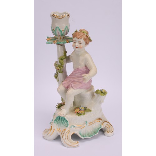 181 - A pair of Continental porcelain figural candlesticks, probably Samson, modelled with seated putto, e... 