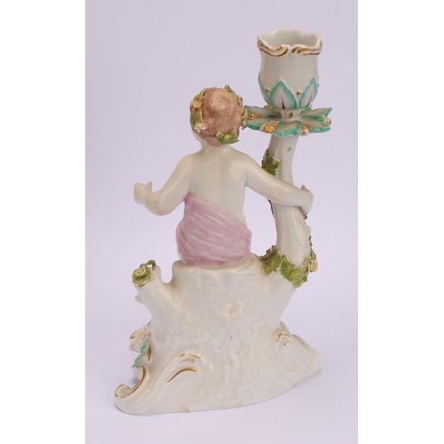 181 - A pair of Continental porcelain figural candlesticks, probably Samson, modelled with seated putto, e... 