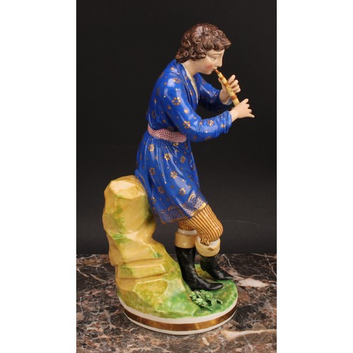 180 - A pair of Bloor Derby figures, of a musician and his companion, he seated on rocky outcrop playing h... 