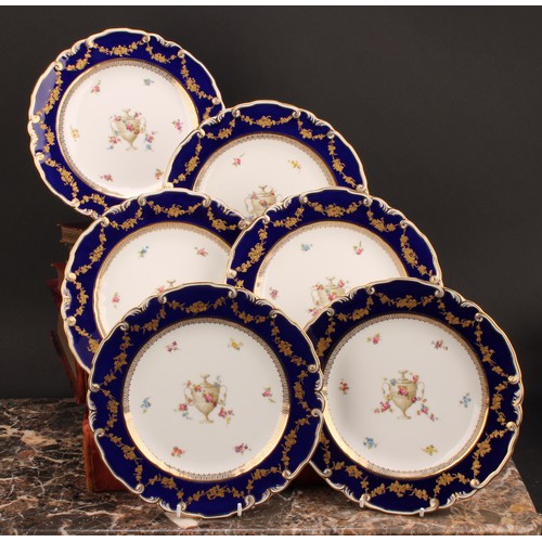 234 - A set of six Royal Crown Derby shaped circular plates, each decorated with a pedestal urn draped in ... 