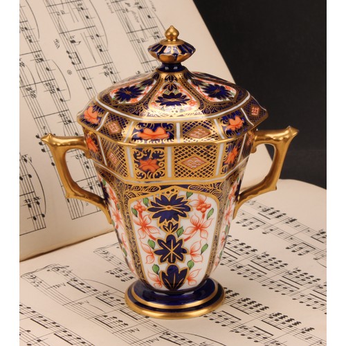 208 - A Royal Crown Derby 1128 Imari pattern hexagonal two-handled pedestal vase and cover, tapering sides... 