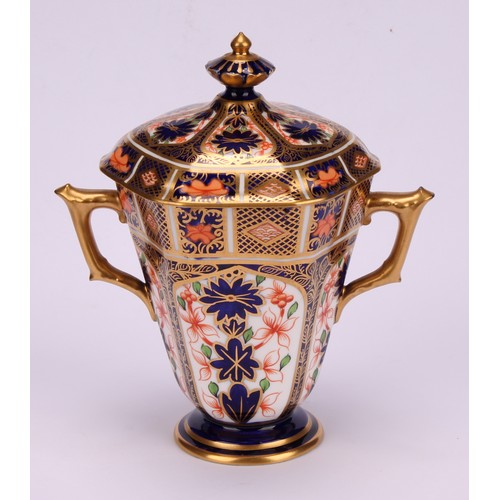 208 - A Royal Crown Derby 1128 Imari pattern hexagonal two-handled pedestal vase and cover, tapering sides... 