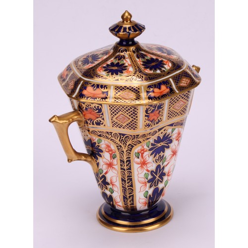 208 - A Royal Crown Derby 1128 Imari pattern hexagonal two-handled pedestal vase and cover, tapering sides... 