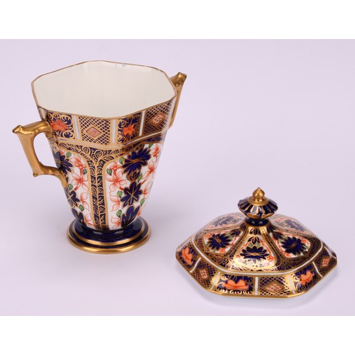 208 - A Royal Crown Derby 1128 Imari pattern hexagonal two-handled pedestal vase and cover, tapering sides... 