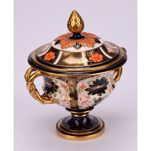 218 - A Royal Crown Derby 1128 Imari pattern two-handled campana shaped vase and cover, naturalistically m... 