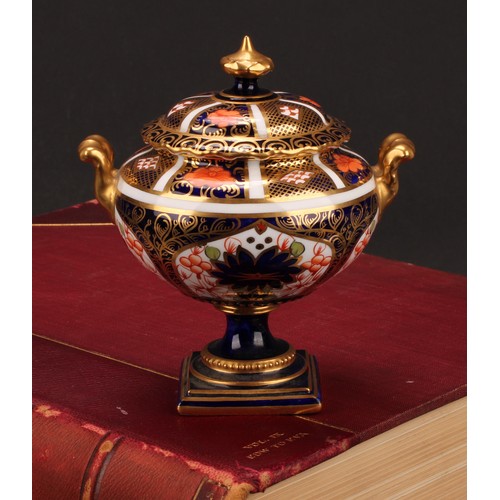 219 - A Royal Crown Derby 1128 Imari pattern two-handled campana shaped vase and cover, of compressed form... 