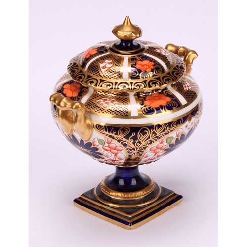 219 - A Royal Crown Derby 1128 Imari pattern two-handled campana shaped vase and cover, of compressed form... 