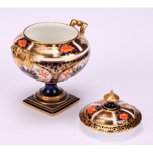 219 - A Royal Crown Derby 1128 Imari pattern two-handled campana shaped vase and cover, of compressed form... 