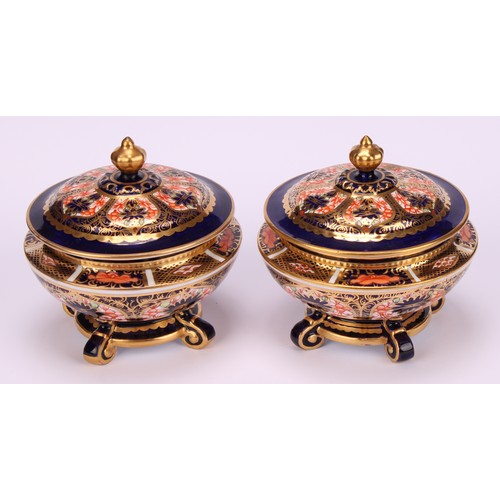 237 - An associated pair of Royal Crown Derby 1128 Imari pattern campana shaped boxes and covers, of compr... 