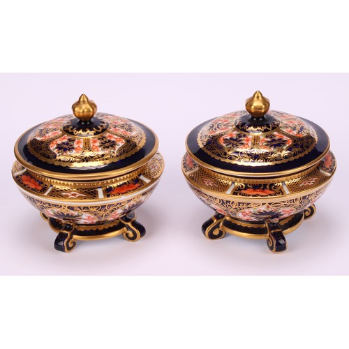 236 - An associated pair of Royal Crown Derby 1128 Imari pattern campana shaped boxes and covers, of compr... 