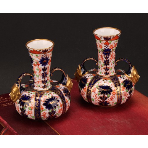 201 - A pair of Royal Crown Derby Imari pattern compressed globular vases, long flared neck with two scrol... 