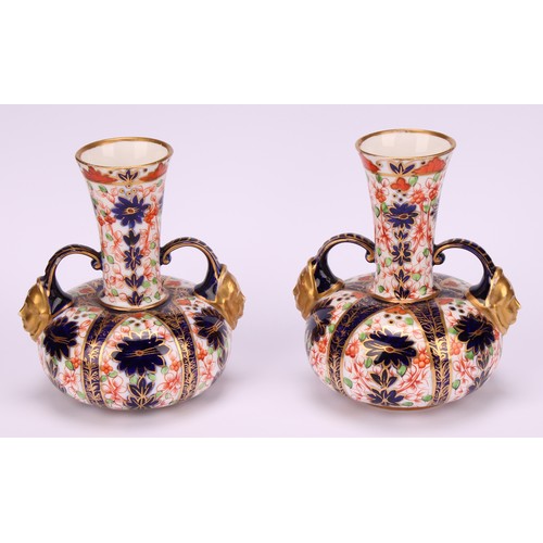 201 - A pair of Royal Crown Derby Imari pattern compressed globular vases, long flared neck with two scrol... 