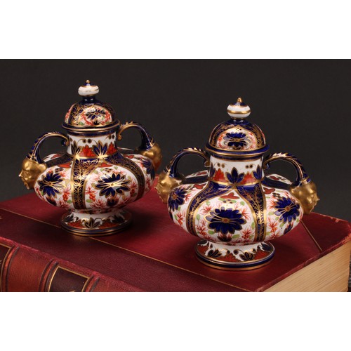 202 - A pair of Royal Crown Derby Imari pattern compressed ovoid two-handled pedestal vases, domed covers,... 