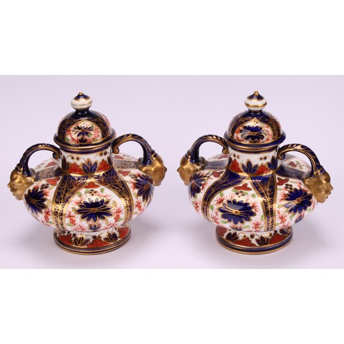 202 - A pair of Royal Crown Derby Imari pattern compressed ovoid two-handled pedestal vases, domed covers,... 