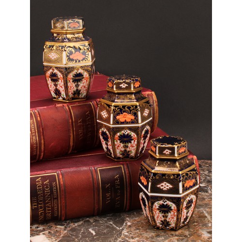 248 - An associated set of three Royal Crown Derby 1128 Imari pattern hexagonal caddies and covers, moulde... 