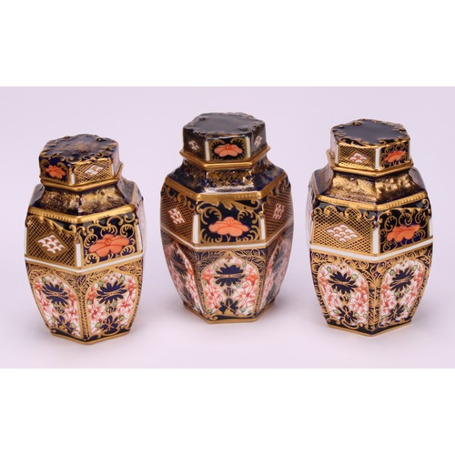 248 - An associated set of three Royal Crown Derby 1128 Imari pattern hexagonal caddies and covers, moulde... 