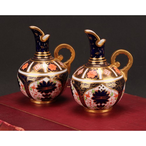 240 - An associated pair of Royal Crown Derby 1128 Imari pattern globular ewers, gilt scroll handles, 12cm... 