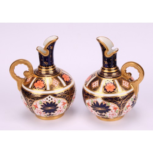 240 - An associated pair of Royal Crown Derby 1128 Imari pattern globular ewers, gilt scroll handles, 12cm... 