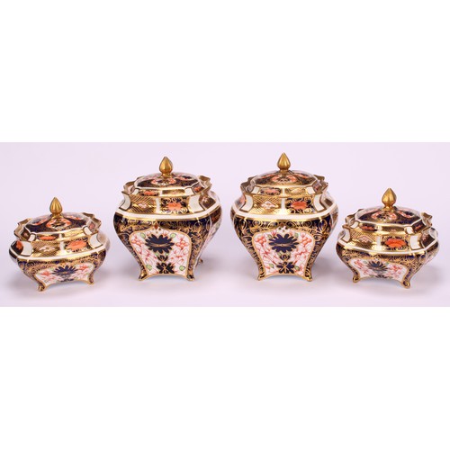 244 - An associated pair of Royal Crown Derby 1128 Imari pattern shaped square boxes and covers, of lobed ... 