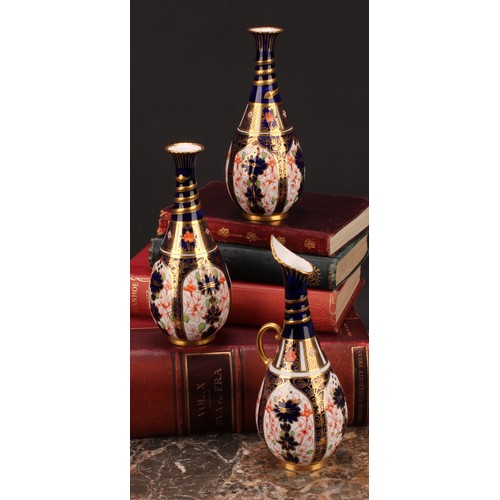 196 - A pair of Royal Crown Derby 1128 Imari pattern ovoid bottle vases, the slender necks moulded with sp... 