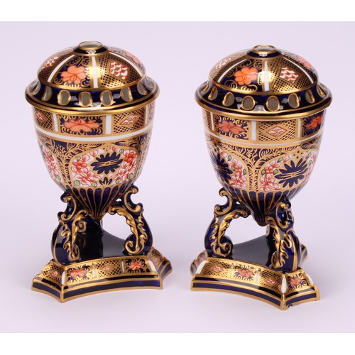 195 - A pair of Royal Crown Derby 1128 Imari pattern egg shaped pedestal pot pourri jars and covers, raise... 