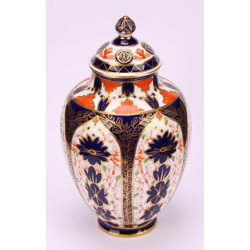 247 - An associated pair of Royal Crown Derby ovoid vases, pierced domed covers and finials, 21cm high, pr... 