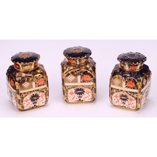 235 - A set of three Royal Crown Derby 1128 pattern shaped rectangular caddies, shaped circular covers, 10... 