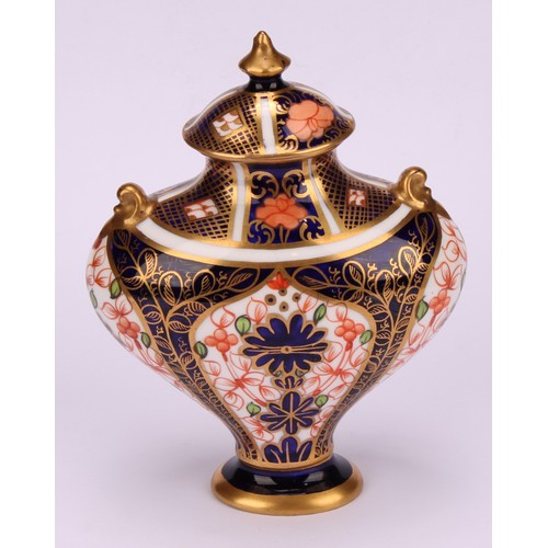 239 - An associated pair of Royal Crown Derby 1128 Imari pattern flattened ovoid pedestal vases, oval dome... 