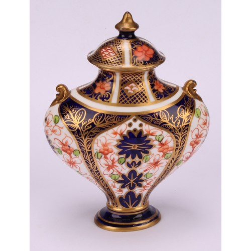 239 - An associated pair of Royal Crown Derby 1128 Imari pattern flattened ovoid pedestal vases, oval dome... 