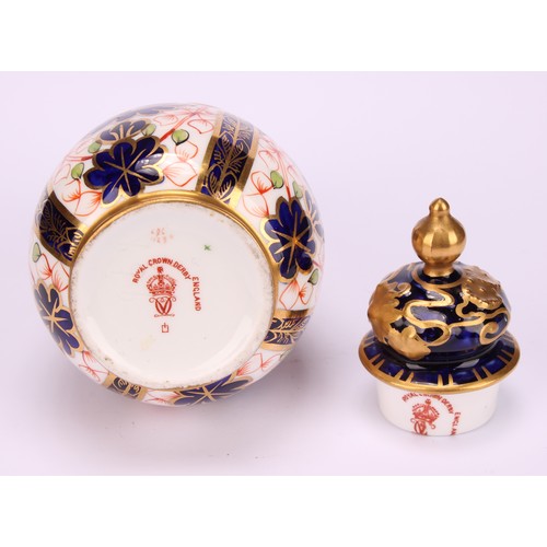 198 - A pair of Royal Crown Derby 1128 Imari pattern ovoid vases, shaped domed covers moulded with sinuous... 