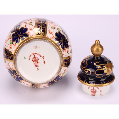 198 - A pair of Royal Crown Derby 1128 Imari pattern ovoid vases, shaped domed covers moulded with sinuous... 