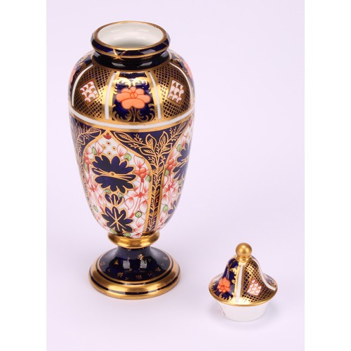 199 - A pair of Royal Crown Derby 1128 Imari pattern slender ovoid pedestal vases, domed covers, gilt ball... 