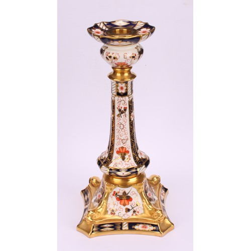 200 - A pair of Royal Crown Derby Imari 2451 pattern Kedleston candlesticks, the square bases with dolphin... 