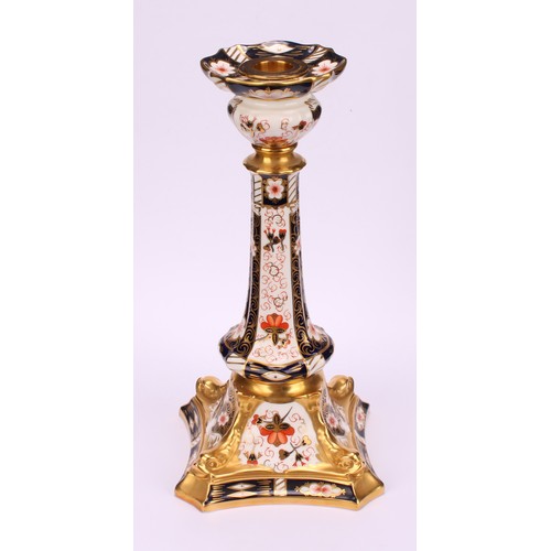 200 - A pair of Royal Crown Derby Imari 2451 pattern Kedleston candlesticks, the square bases with dolphin... 