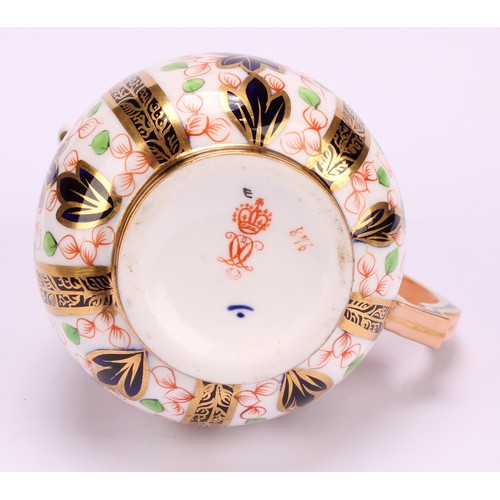 193 - A Derby Crown Porcelain Company Imari palette 1128 pattern milk jug and two handled sucrier and cove... 