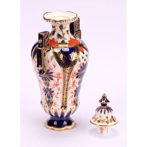 228 - A Royal Crown Derby Imari elongated ogee shaped two-handled vase and cover, Japanesque angular handl... 