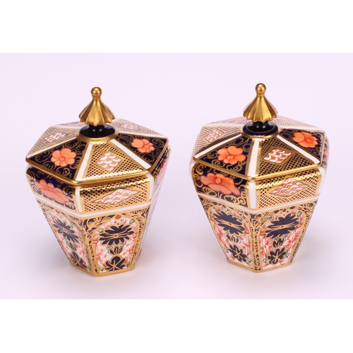 245 - An associated pair of Royal Crown Derby 1128 Imari pattern tapered hexagonal jars and covers, 10cm h... 