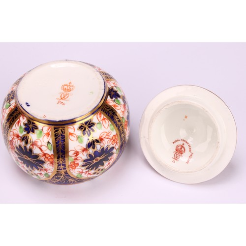 245 - An associated pair of Royal Crown Derby 1128 Imari pattern tapered hexagonal jars and covers, 10cm h... 