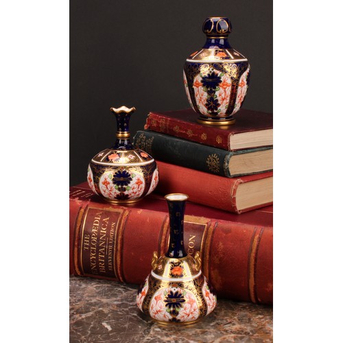 217 - A Royal Crown Derby 1128 Imari pattern two-handled bottle vase, of conical form, swan neck handles, ... 