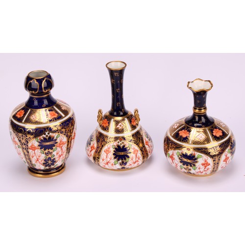 217 - A Royal Crown Derby 1128 Imari pattern two-handled bottle vase, of conical form, swan neck handles, ... 