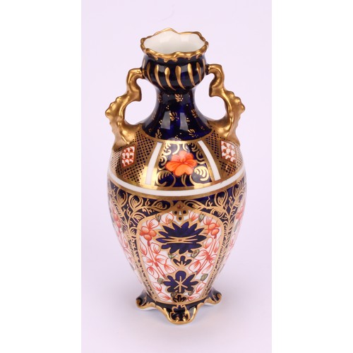 207 - A Royal Crown Derby 1128 Imari pattern flattened ovoid two-handled vase, rococo style handles, four ... 