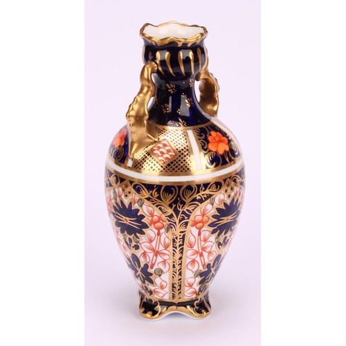 207 - A Royal Crown Derby 1128 Imari pattern flattened ovoid two-handled vase, rococo style handles, four ... 