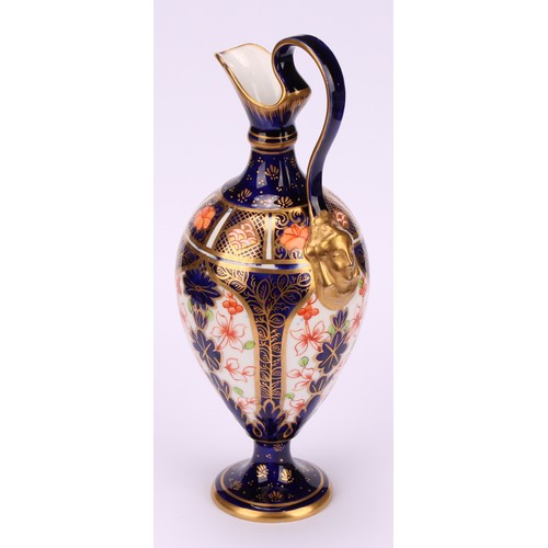 212 - A Royal Crown Derby 1128 Imari pattern pedestal ewer, scroll handle with mask terminal, circular bas... 