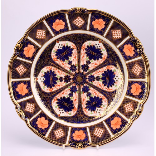 230 - A Royal Crown Derby Imari pattern shaped circular plate, the borders moulded with acorns, 23cm diame... 